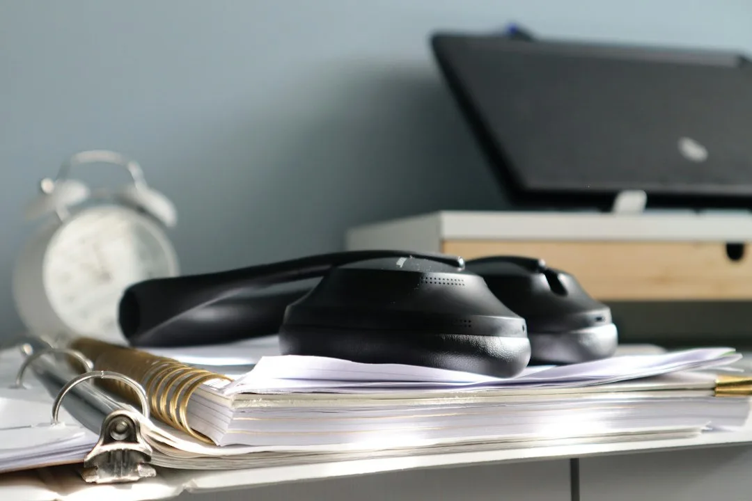 Stack of business documents and a rubber stamp on a desk ready for licence filing